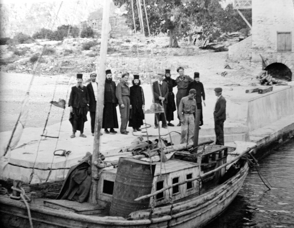 New Zealand soldiers pose with monks in front of a local fishing boat, or caique, at a monastery on Mount Athos in 1944. 