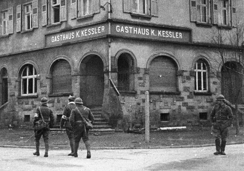 Black and white photo of French troops in a German town.