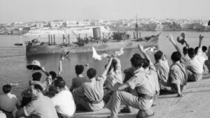 Soldiers cheer as a convoy enters Valletta harbour.